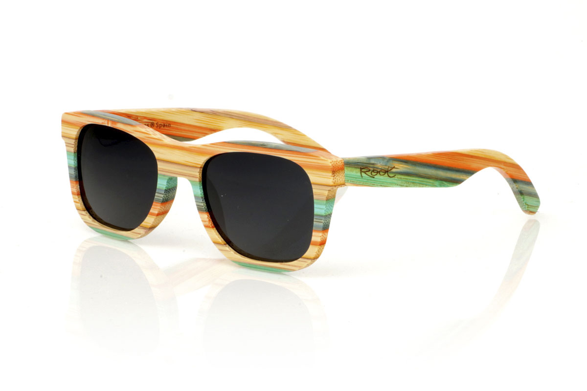 Wood eyewear of Bamboo KASHBAH. KASHBAH sunglasses, with a classic design and a slightly smaller size than the standard, make the difference in our bamboo collection. These glasses are made of vertically laminated bamboo wood, creating a pattern of soft colors that capture the light and the gaze of whoever sees them. The colorful result is not only visually attractive, but also adds a touch of originality and freshness to your style. With measurements of 143x46 and a caliber of 52, the KASHBAH are perfect for those looking for comfortable, light glasses with a unique touch that will not go unnoticed. for Wholesale & Retail | Root Sunglasses® 